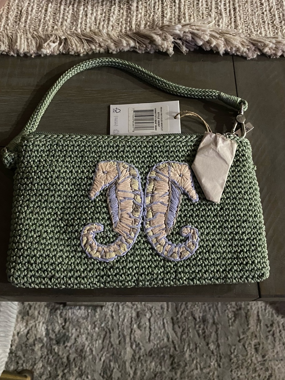 The Sak Sage Green Woven Wristlet with Embroidered Twin Seahorses